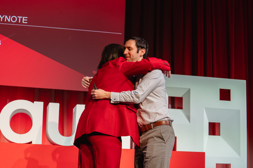 speakers-hugging-on-stage